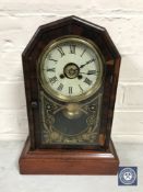 A mahogany and walnut cased walnut mantel clock with pendulum and key