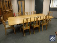 A contemporary light oak dining table (length 274 cm), on wrought iron understretcher,