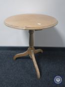 A pine pedestal wine table