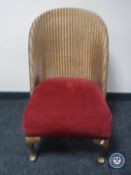 A gold Lloyd Loom basket chair