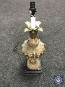 An antique gilded table lamp on metal base