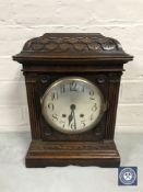 A carved oak cased Lenzkirch bracket clock with silvered dial,
