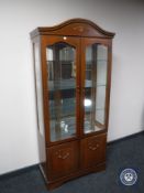 A contemporary display cabinet fitted with cupboards beneath