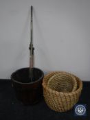 An oak coopered bucket together with two wicker baskets and an antique brass rail