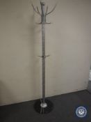 A hat and coat stand on a marble base