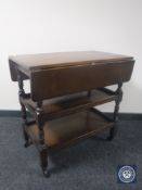An oak three tier flap sided tea trolley