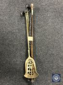 An antique brass coal shovel and fire poker,