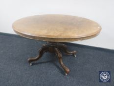 A Victorian burr walnut oval pedestal breakfast table