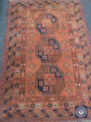 Turkmen rug, North Afghanistan, the terracotta field with three elephant foot guls,