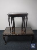 A nest of three glass topped tables and a coffee table