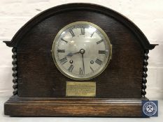 An oak cased Empire mantel clock with barley twist column supports and enamelled dial,