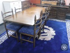 A ten-piece oak dining room suite comprising of low four-door sideboard,