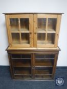 An oak double door glazed wall cabinet and a pine wall cabinet