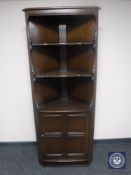An Ercol corner cabinet