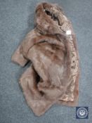 A lady's fur coat, brown, size 10.