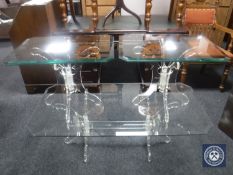 A glass topped coffee table on base and pair of matching lamp tables