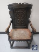 A late Victorian carved oak hall chair