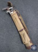 A mid 20th century golf bag containing assorted irons and drivers and a draughtsman's set square
