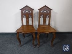 A pair of Victorian mahogany hall chairs