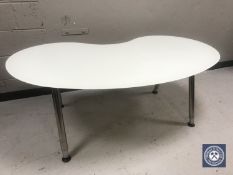 A contemporary glass topped kidney shaped computer desk
