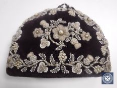 An Edwardian elaborately beaded tea cosy.
