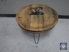 An oak barrel top coffee table on metal legs