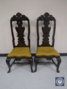 A pair of antique carved high backed dining chairs