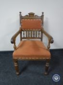 A Victorian oak scroll arm armchair