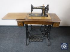 A Singer treadle sewing machine in mahogany table