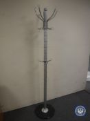 A hat and coat stand on a marble base