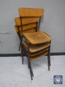 A set of four mid 20th century school stacking chairs