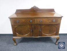 An early 20th century mahogany sideboard on claw and ball feet