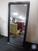 A black framed hall mirror