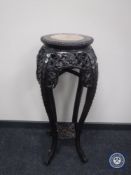 A Chinese carved rosewood jardiniere stand with inset rouge marble top, height 91 cm.