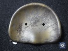 A vintage metal tractor seat