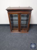 An oak double door hanging wall cabinet