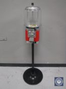 A gum ball machine on stand with key