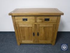 A contemporary oak double door sideboard CONDITION REPORT: 100cm wide by 43cm deep