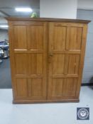 An early 20th century double door pitch pine school cupboard