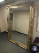 A large silvered framed floor standing mirror,