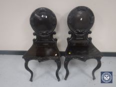 A pair of Victorian hall chairs on cabriole legs