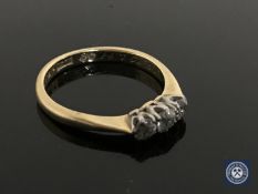 An 18ct gold three-stone diamond ring, size K CONDITION REPORT: 2.