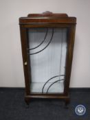 A mahogany glazed door display cabinet on claw and ball feet