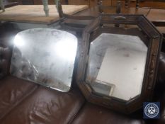 An antique oak octagonal framed bevelled mirror together with one other