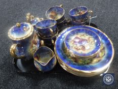 A tray containing a twenty-one piece hand-painted Marquis tea and dinner service