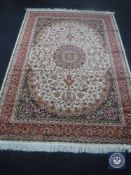 A Keshan carpet, on beige ground,