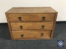 A 20th century oak three-drawer chest