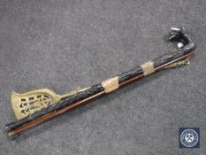 An antique brass coal shovel and fire poker plus two walking sticks