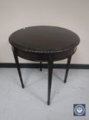 A circular Victorian mahogany occasional table with glass top