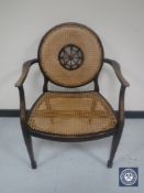 A 20th century oak bergere armchair